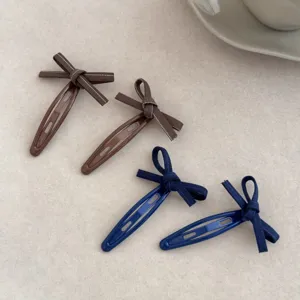 Detailed view of 4 Korean style sweet bow hair clips in brown and navy blue denim ribbon.