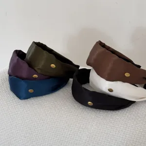 Group of retro wide headbands in satin finish with elegant gold label accents