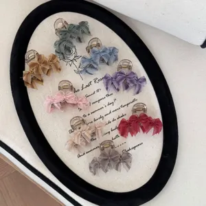 Detailed assortment of elegant mesh bow hair claw clips in eight colors on a tray