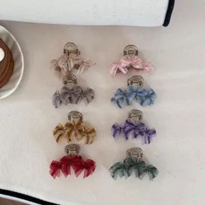 Elegant mesh bow claw clips in eight colors displayed on a neutral fabric background