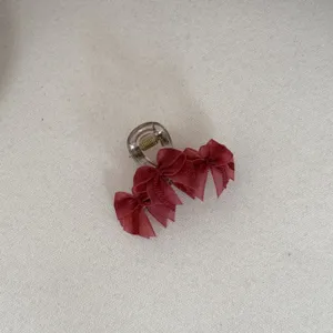 Detailed view of an elegant burgundy mesh bow hair claw clip for women's hairstyling