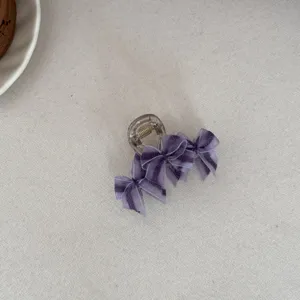 Detail view of a purple mesh bow hair claw clip with an elegant Mori style design