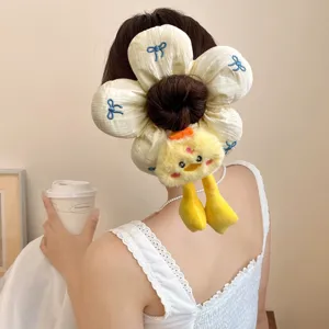 Cute flower sponge scrunchie with plush chick detail for elegant bun hairstyles.