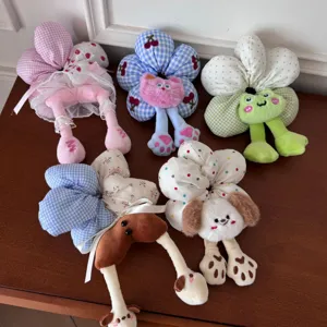 Detailed view of various cute plush flower hair scrunchies with animal feet designs