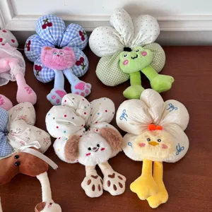 Detailed view of colorful plush flower hair scrunchies with cute animal characters