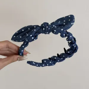 Detalle de la diadema retro de lunares con dientes antideslizantes y un lindo lazo de moño.