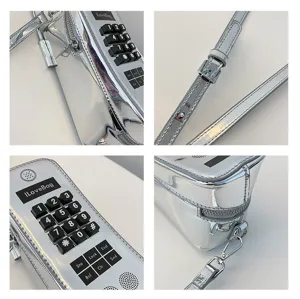 Detail view of silver vintage brick phone crossbody bag with tactile buttons and strap
