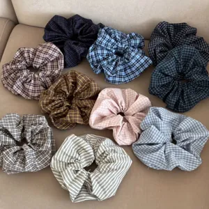 Group of various checkered and striped fabric scrunchies for hair styling accessories