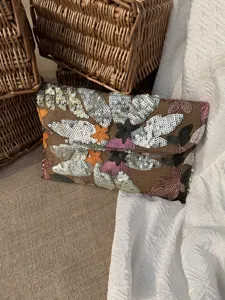 Detailed view of floral sequin embroidery on high-end evening envelope clutch bag