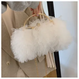 Close-up of elegant white mesh ruffle evening clutch bag with gold handle and chain