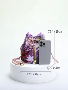 Size detail of purple floral embroidered sequin bucket bag with drawstring and chain strap