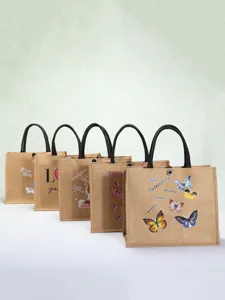 Collection of eco-friendly printed jute tote bags with black handles and butterfly patterns