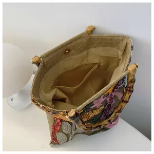 Linen embroidered tote bag detail showing internal zipper pocket and snap closure
