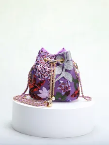Close-up of elegant purple bucket bag with intricate floral embroidery and sequins.