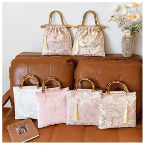 Detailed view of floral embroidery and bamboo handles on vintage evening handbags