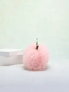 Dettaglio dell'elegante borsa da sera in pizzo rosa con manico ad anello in metallo oro