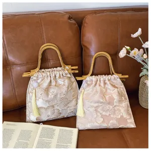 Detailed view of floral embroidery and bamboo handles on elegant evening bags