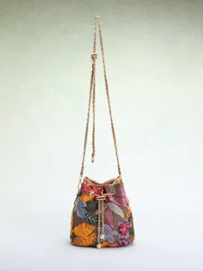 Detail showing vibrant floral embroidery and shimmering sequins on a mesh bucket bag.