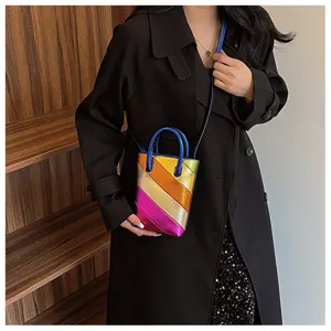 Close-up of vibrant rainbow striped PU patchwork bucket bag with metallic finish