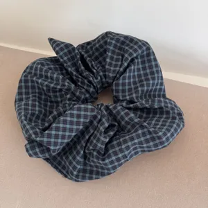 Detailed view of the blue and black checkered fabric texture of a large scrunchie