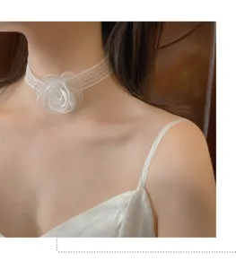 Macro view of a white lace choker featuring a delicate layered organza flower detail