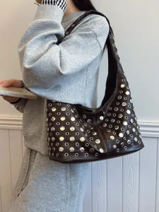 Fashionable brown shoulder bag with silver rivet and eyelet accents, stylish Y2K hobo tote.