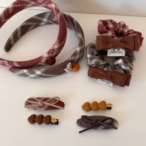 Collection of retro plaid hair accessories including headbands, bow scrunchies and heart clips.