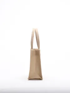 Side profile view of a natural eco-friendly burlap jute tote bag with reinforced handles