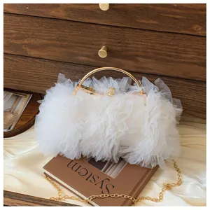 Macro view of white ruffled tulle texture on an elegant evening handbag detail