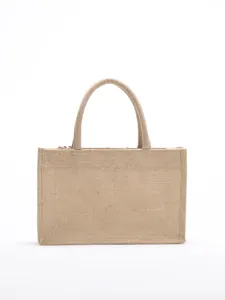 Detailed view of a natural burlap jute tote bag with sequin embroidery accents.