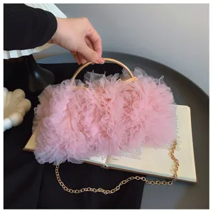 Detailed view of pink ruffled tulle evening clutch bag featuring elegant golden ring handle