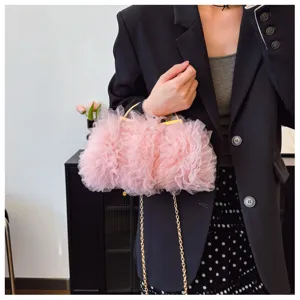 Detailed view of a sweet pink ruffled lace evening handbag with golden chain strap