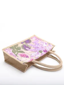Side view detail of a woven tote bag featuring intricate purple sequin floral embroidery