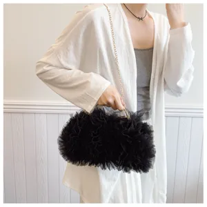 Detail view of a black ruffled tulle clutch bag for evening parties and weddings