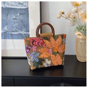 Borsa a mano artistica in lino con ricami floreali di paillettes e manico vintage.