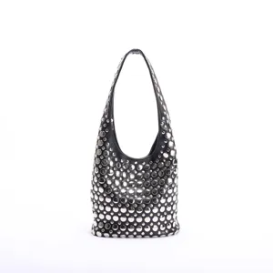 Close-up of polished silver rivets on a black leather hobo-style shoulder bag for women