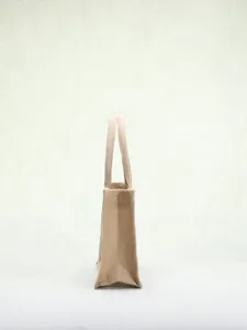 High-quality woven jute tote bag for women, featuring a minimalist textured design