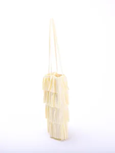 Side view of cream multi-layer pleated ruffle tote bag with thin shoulder straps