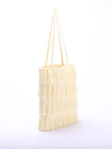 Side angle view of an elegant cream multi-layered pleated tiered tote bag with straps