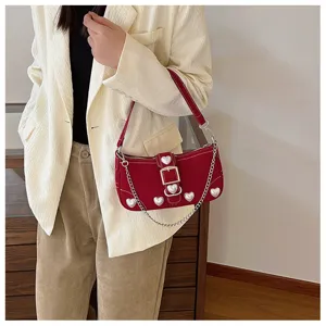 Stylish red baguette bag with pearl heart embellishments and silver chain worn on shoulder