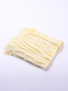 Detail view showing the multi-layer pleated texture of a cream ruffled tote bag