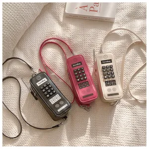 Macro view of creative retro phone-shaped crossbody bags in three vintage colors
