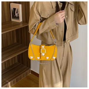 Sweet yellow baguette shoulder bag with pearl heart accents and silver chain detail