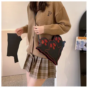 Halloween heart-shaped crossbody bag featuring red ghost print worn by an Asian model