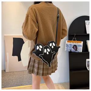 Black triple ghost silhouette crossbody bag for Halloween shown on a female model