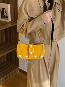 Elegant yellow baguette shoulder bag with sweet pearl heart accents and chain strap