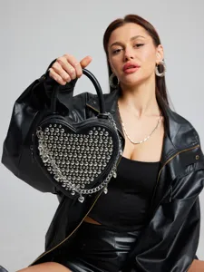 Black studded heart-shaped crossbody bag with chain and tassel for women fashion style.