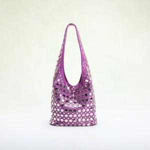 Detailed view of punk style purple bucket bag with silver stud embellishments.