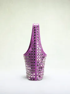 Detailed close-up of a purple punk-style bucket bag with shiny silver stud embellishments.
