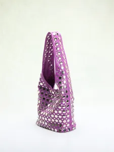 Close-up detail of a stylish purple hobo bag with silver rivet inlays in punk style.
